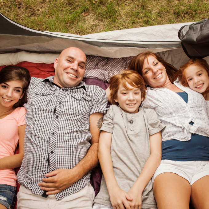 Portrait of family with three children in tent