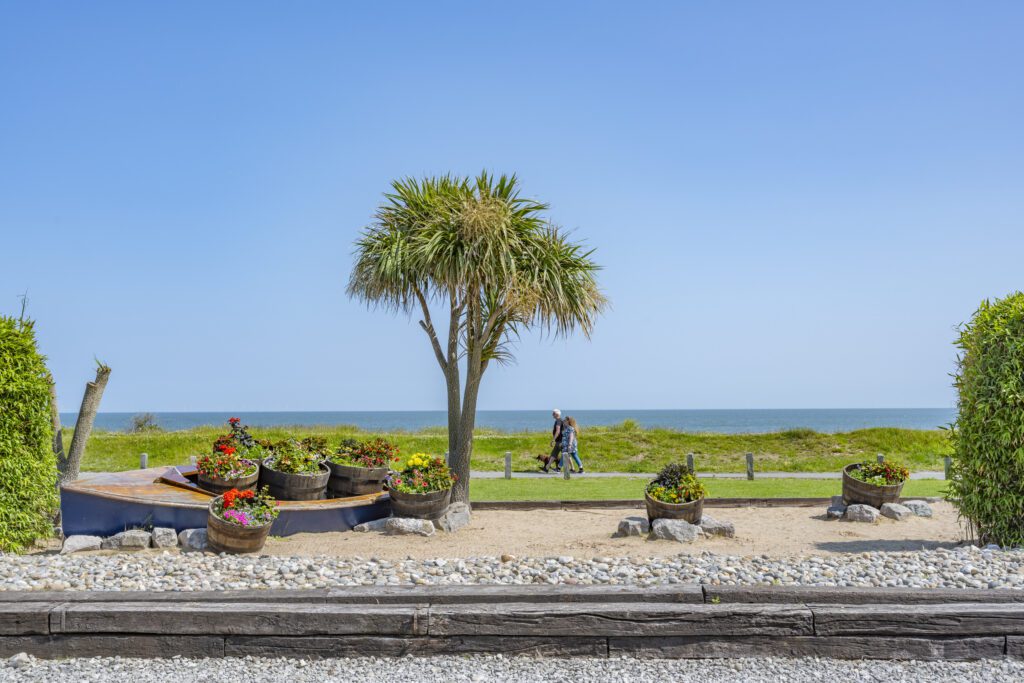 couple walking near a Conwy caravan park along the North Wales coast