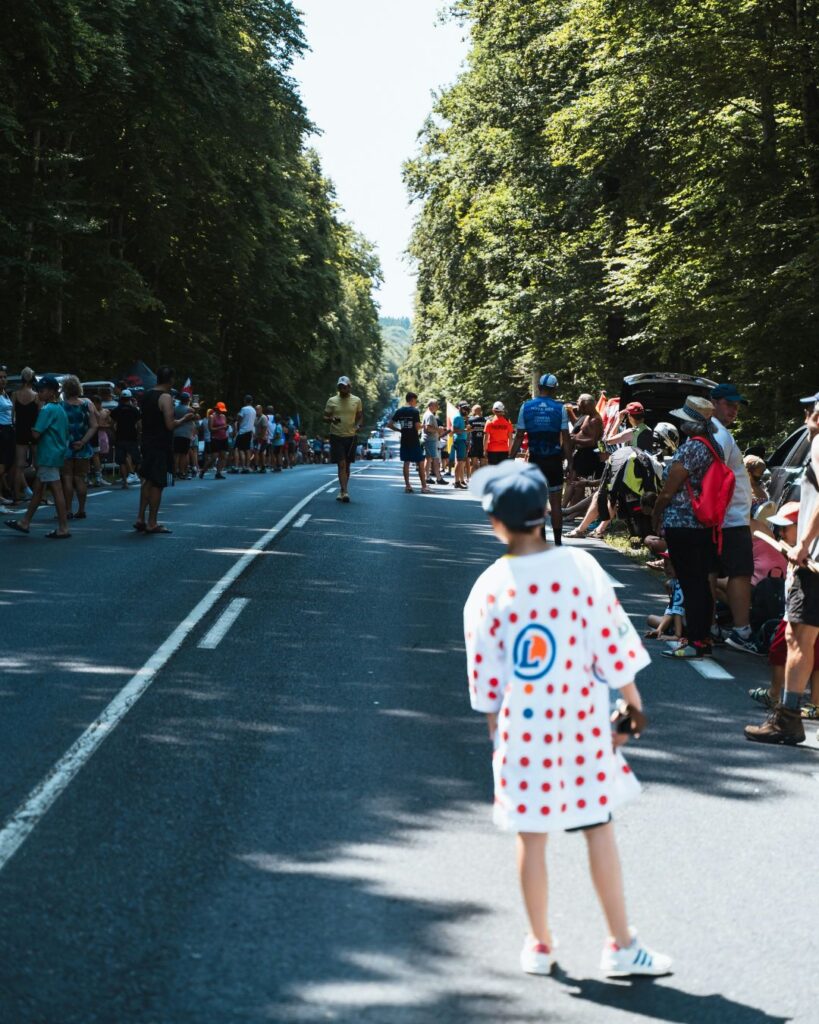 Spectators watching professional cyclists during the Tour de France in Wales.