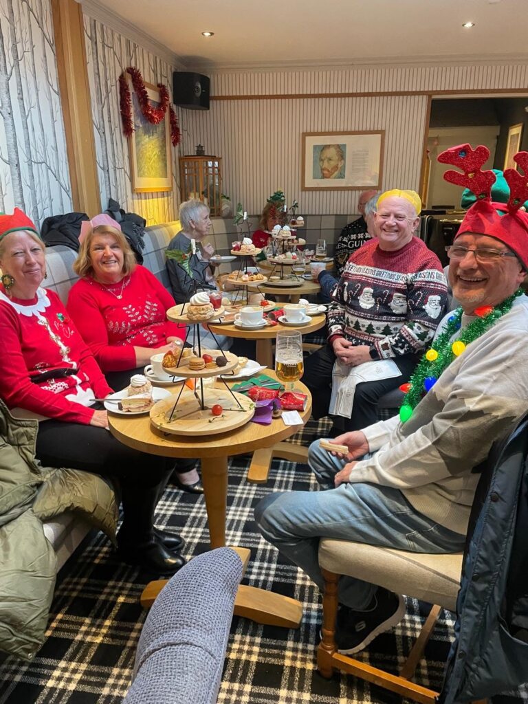 Guests wearing festive clothing at a Christmas afternoon tea