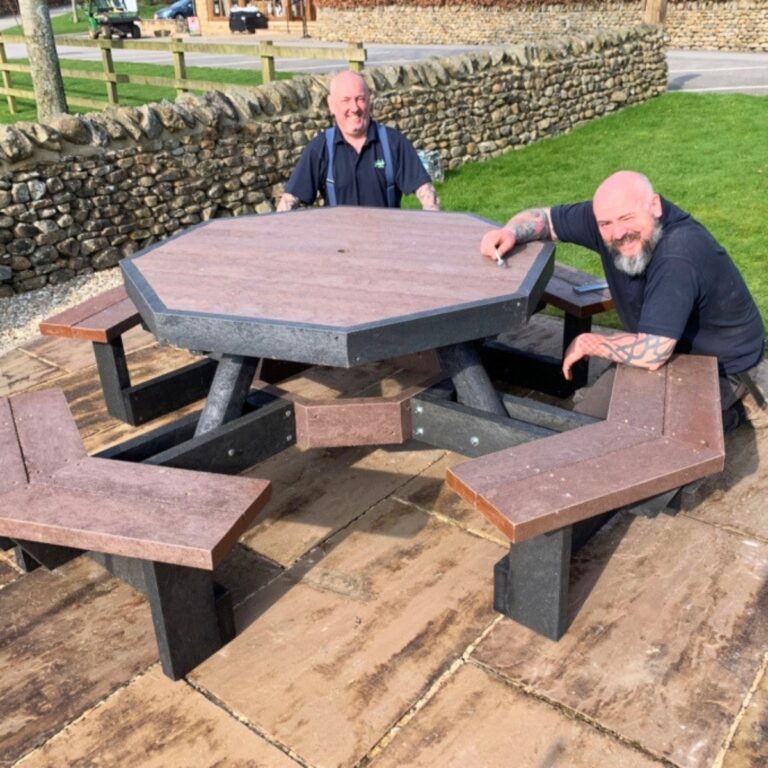 Grounds team assembling a recycled-plastic picnic table