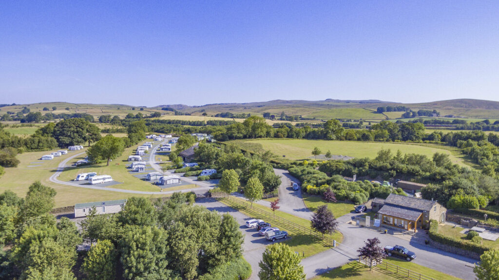 Aerial view of Gallaber Park’s touring pitches and buildings surrounded by green countryside.